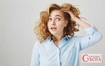 Girl touching curly hair deciding go hairdresser 1300x820